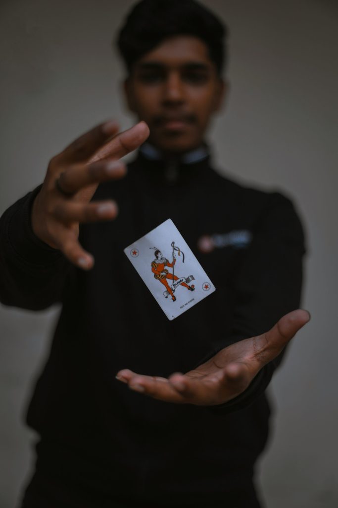 man holding playing card